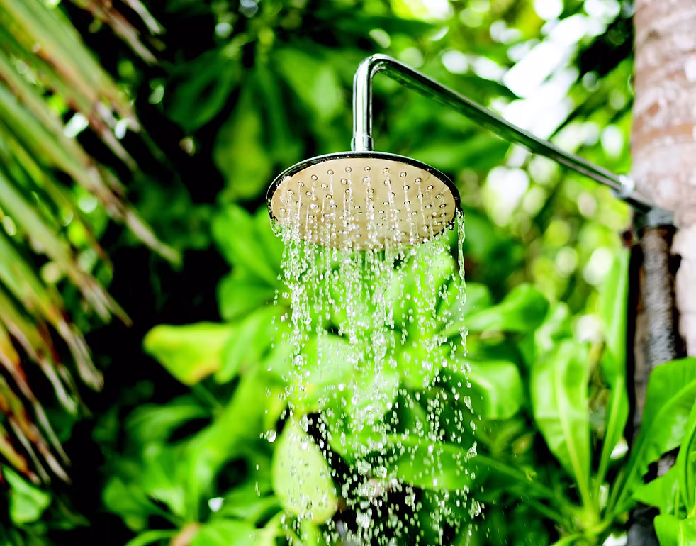 Outdoor shower running with hot water supplied by an energy-efficient Daikin heat pump hot water system